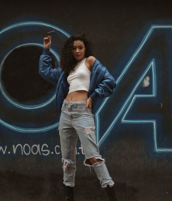 Female coordinator portrait with neon border and street art background