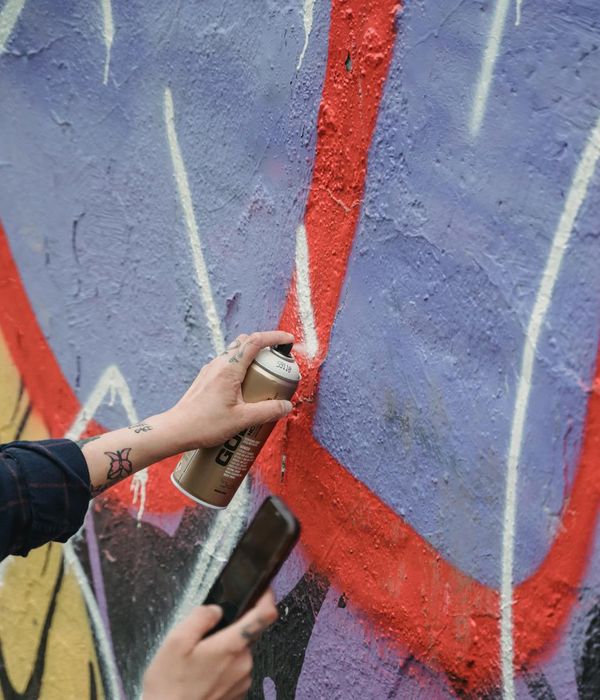 Street art mural showing travel services with graffiti style icons and neon spray effects